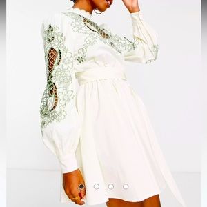 ASOS DESIGN high neck cutwork belted mini dress in stone with green detail.
